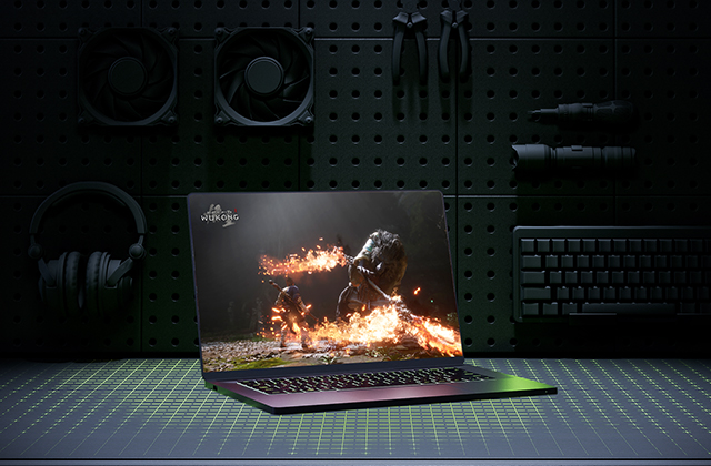 Laptop sitting on a desk. Computer accessories and other items are displayed behind the laptop. Accessories include computers fans, clamps, a lightsaber, keyboard and headphones. A square green grid is shown on the surface of the desk, underneath the laptop.